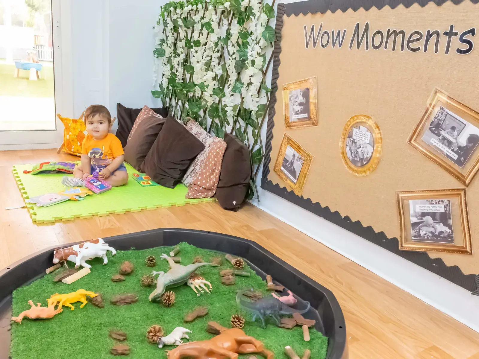 Baby sitting on floor in classroom